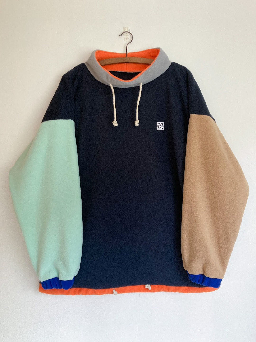Navy fleece with contrasting sleeves.