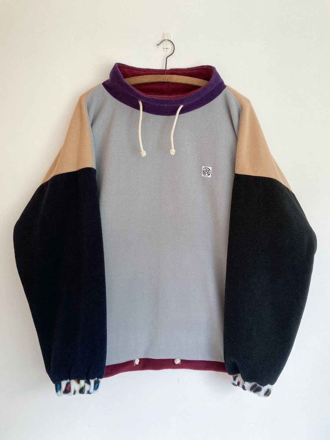 Grey and camel coloured fleece with contrasting sleeves.