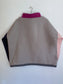 Cotton pullover in orange with one pale pink sleeve and one navy blue sleeve. Grey back panel and fuchsia pink collar with drawstring.