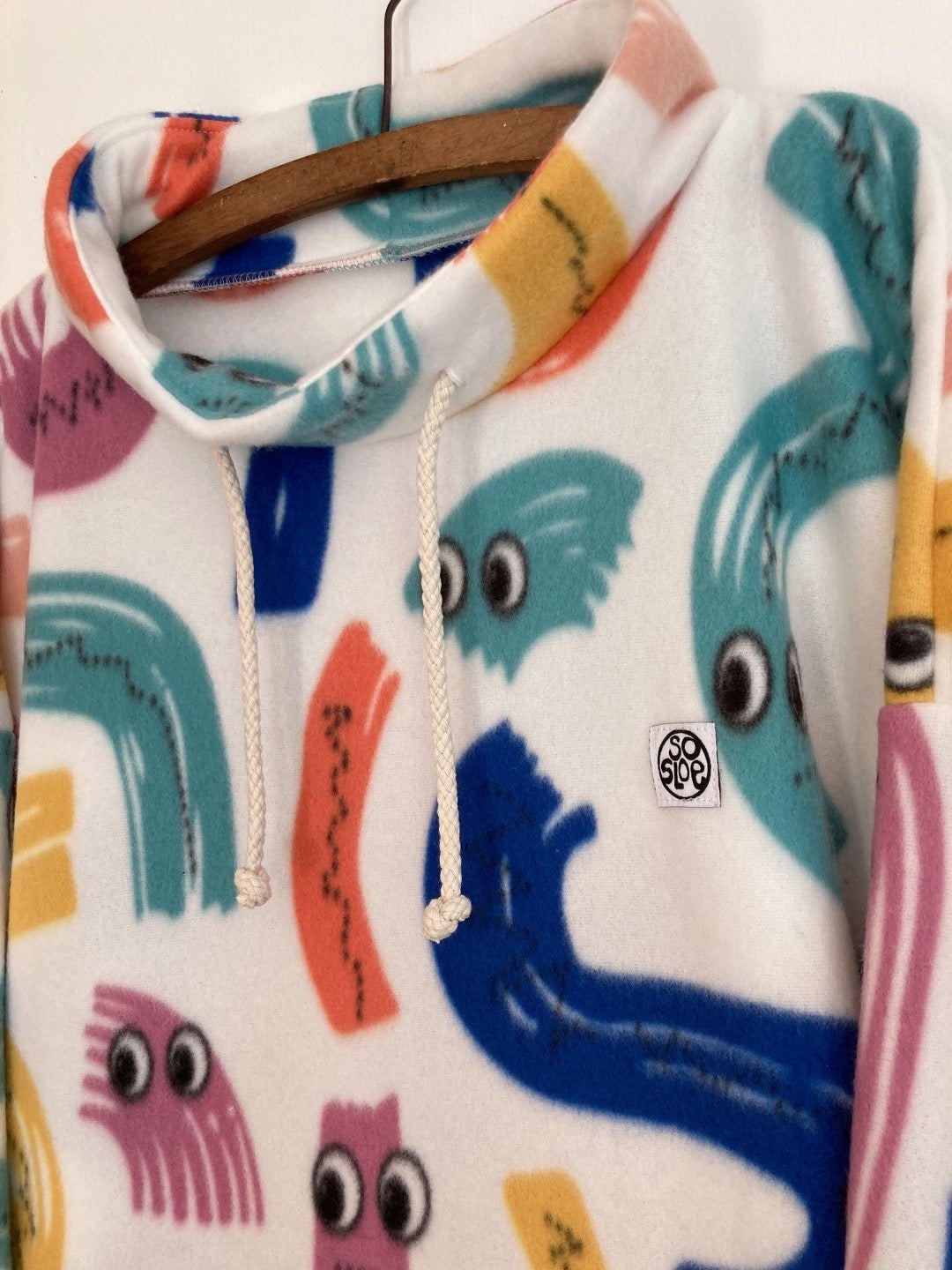 multi coloured fleece pullover with squiggles. 