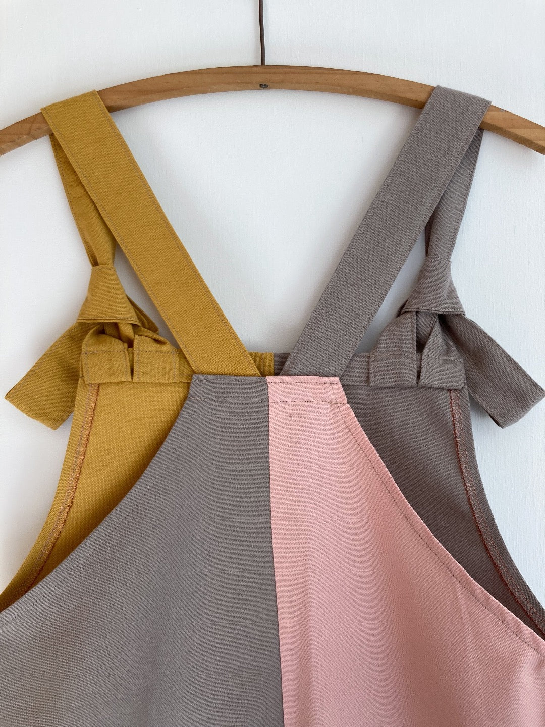 Grey and yellow cotton pinafore dress with pink back panel.