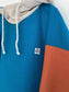 Block panel hooded pullover, teal, orange, stone and blue.