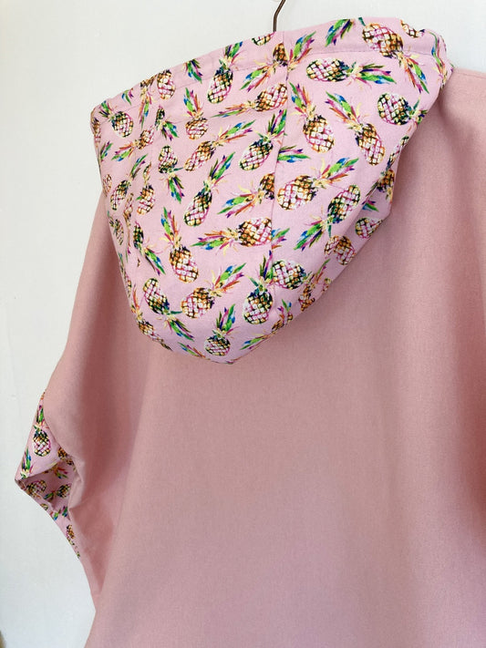 Pink cotton pullover with pineapple print hood and sleeves.