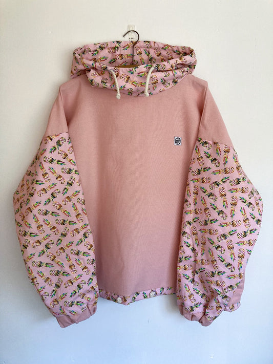 Pink cotton pullover with pineapple print hood and sleeves.