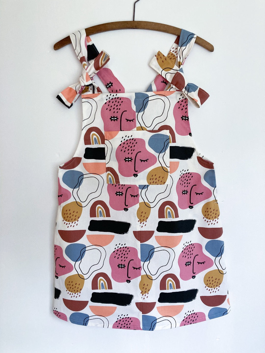 Multi coloured cotton pini dress with faces/shapes