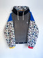 Block coloured fleece with white leopard print inner hood and sleeves. 