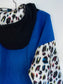 Back view, blue back panel, black hood and white leopard sleeves